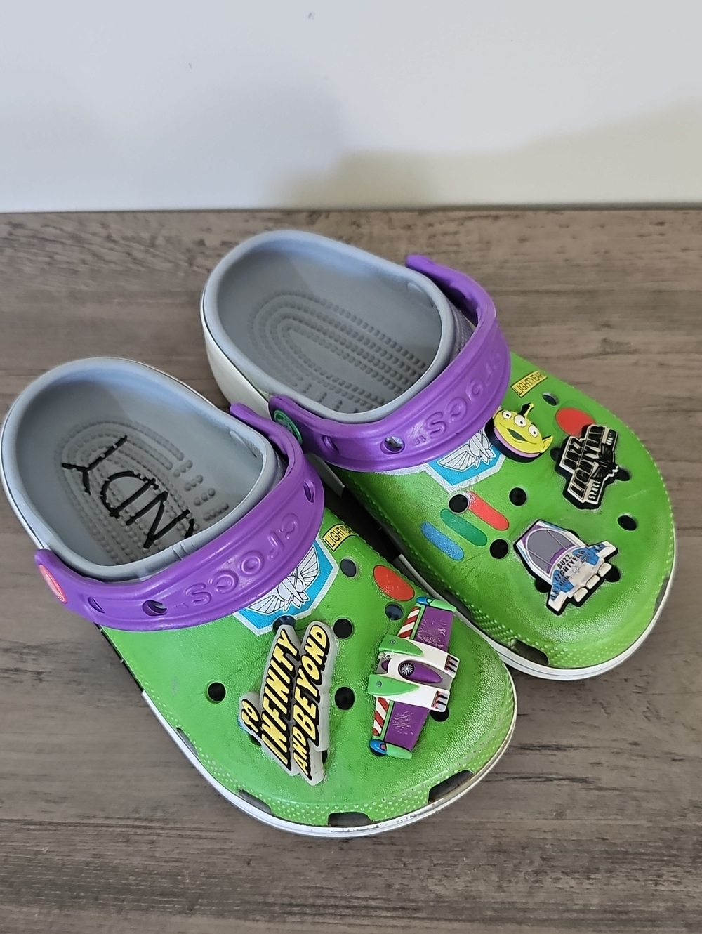 Crocs Kids Green and Purple Clog Shoes with Toy Story Charms Boy Girl J 1